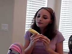 She eats banana and teases camera with gentle bites and licking