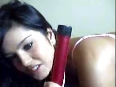 Lewd and hot webcam brunette called Sunny Leone sucks red sex toy