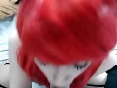 Red haired girl sucks on dildo