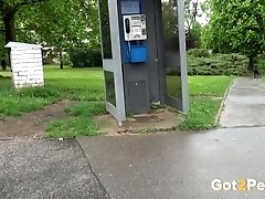 Blond haired chick pulls down jeans and piss in the phonebox