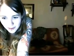 Two lubricious coeds with tattoos are fooling around in front of a webcam