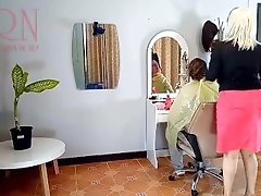 Nudist barbershop. Nude lady hairdresser in an apron. Voyeur camera. The client is surprised. 1