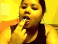 Chubby mulatto chick sucks her fingers and caresses her large titties