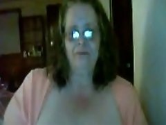Slutty granny shows her big tits and smokes in front of a webcam