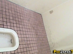 Squatting asians urinate into toilet