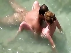 Amateur couple is caught having foreplay right on the beach
