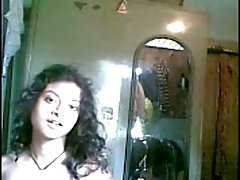 Cute curly haired Desi gal flashed her tits while stripping on camera